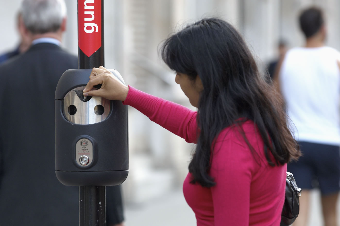 A woman using a City of London Smartbin